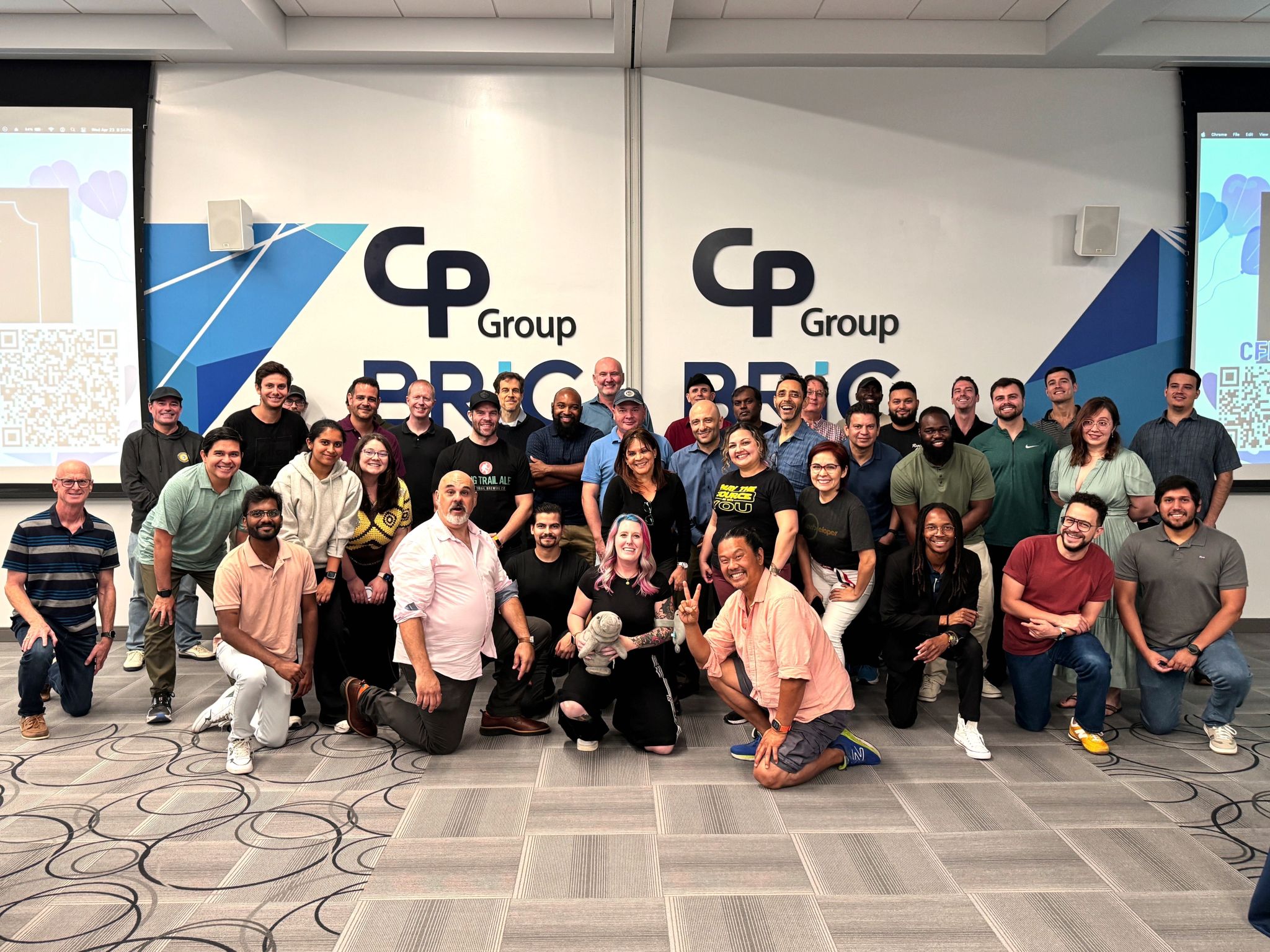 Group of 40 tech professionals standing together smiling